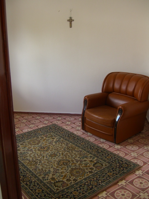 Chair and contrasting carpet and tiles. 